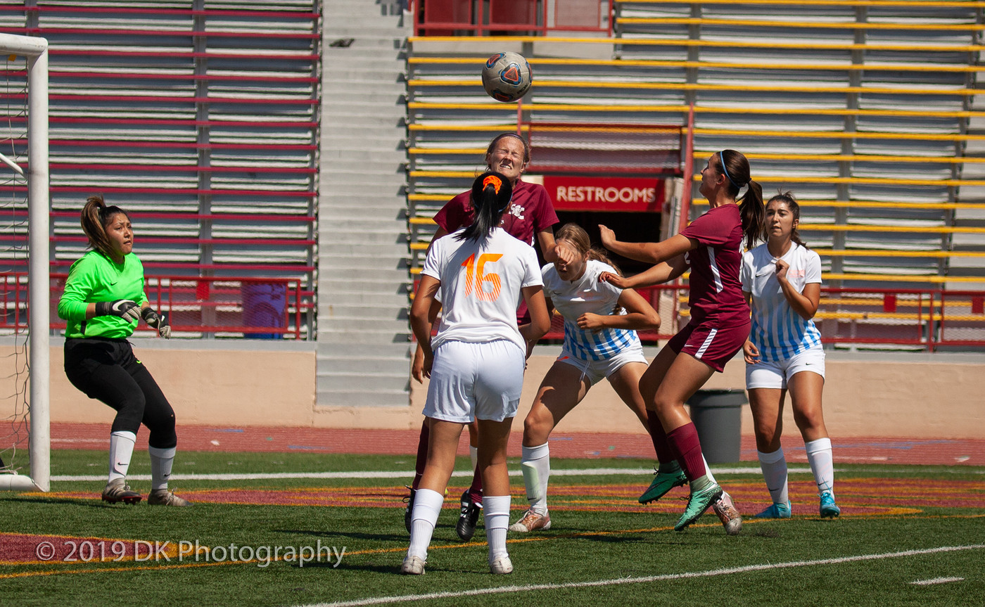 Olivia Foulk (#5), City College freshman gets the head stop in the match against Sequoias at Hughes Stadium on Sept. 10th.