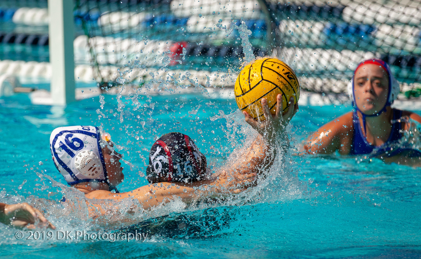 Jade Grey-Aleman (#16), City College freshman is smothered as she attempts a goal shot in the match against Citrus College at ARC Pool on Sept. 13th.