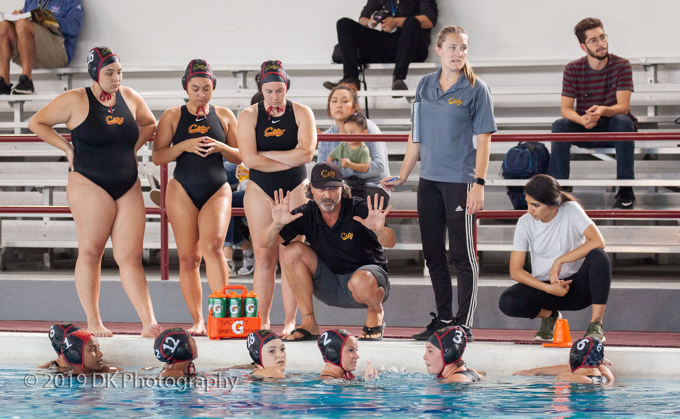 City College head coach Steve Hanson talks to the team during a time out in the match against Fresno City College at the Hoos Pool on Sept. 18th.