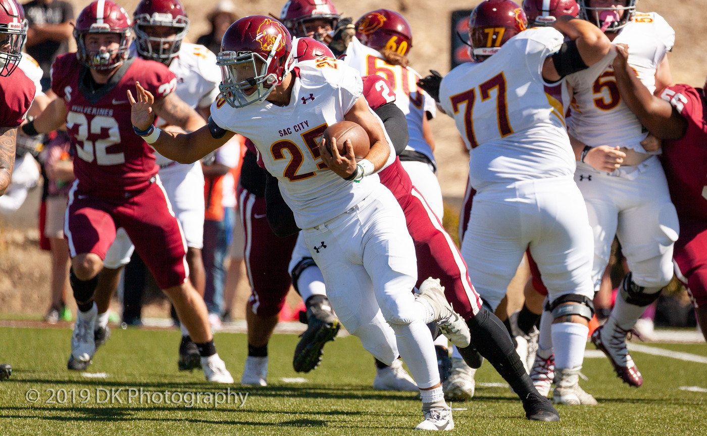 Major Niccum (#25), City College freshman running back looks for room as he runs the ball in the game against Sierra College at Homer 