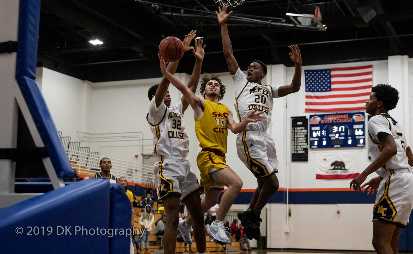 Jake Paxton (#10), City College freshman fights to get to the basket in the game against Merced College at the Cosumnes River Gym in the James Clark Classic on Dec. 5th. 