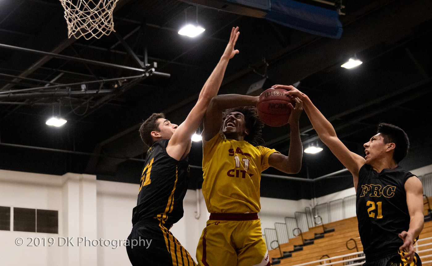 Ryan Reed  (#11), City College sophomore gets fouled as he goes to basket in the game against Feather River College at the Clark Gym in the James Clark Classic on Dec. 6th. 