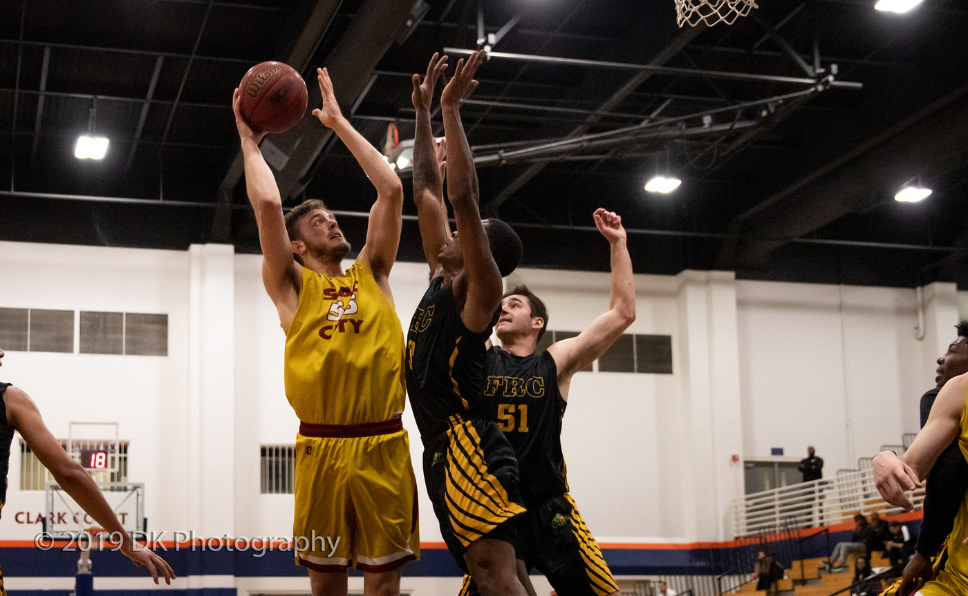 Terry Moody (#55), City College sophomore shoots over the defenders for two in the game against Feather River College at the Clark Gym in the James Clark Classic on Dec. 6th.