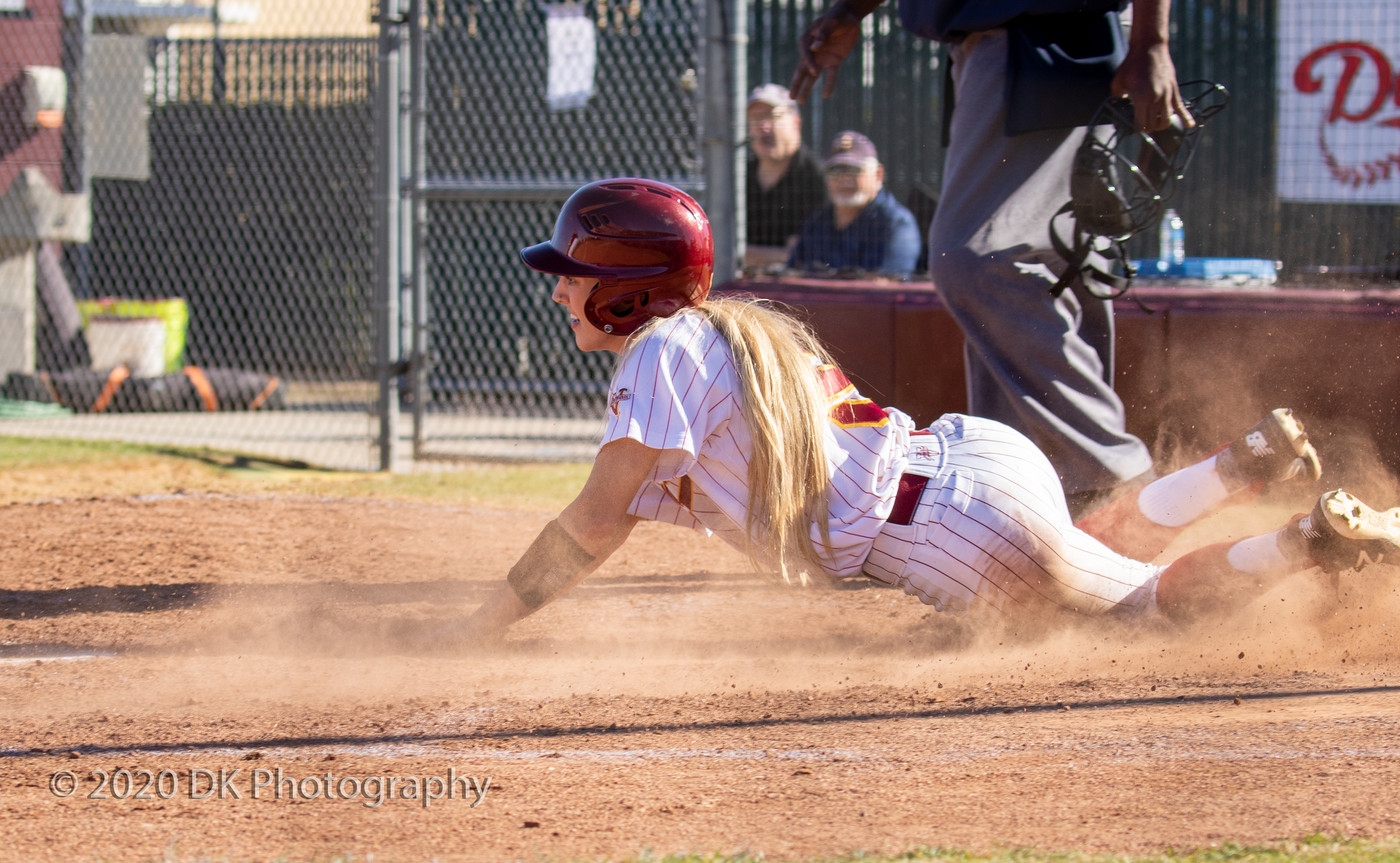 Shelby Lloyd (#5), City College sophomore slides across home with the winning rum in the first game of a double header against Merced College at The Yard on Feb. 11th. 