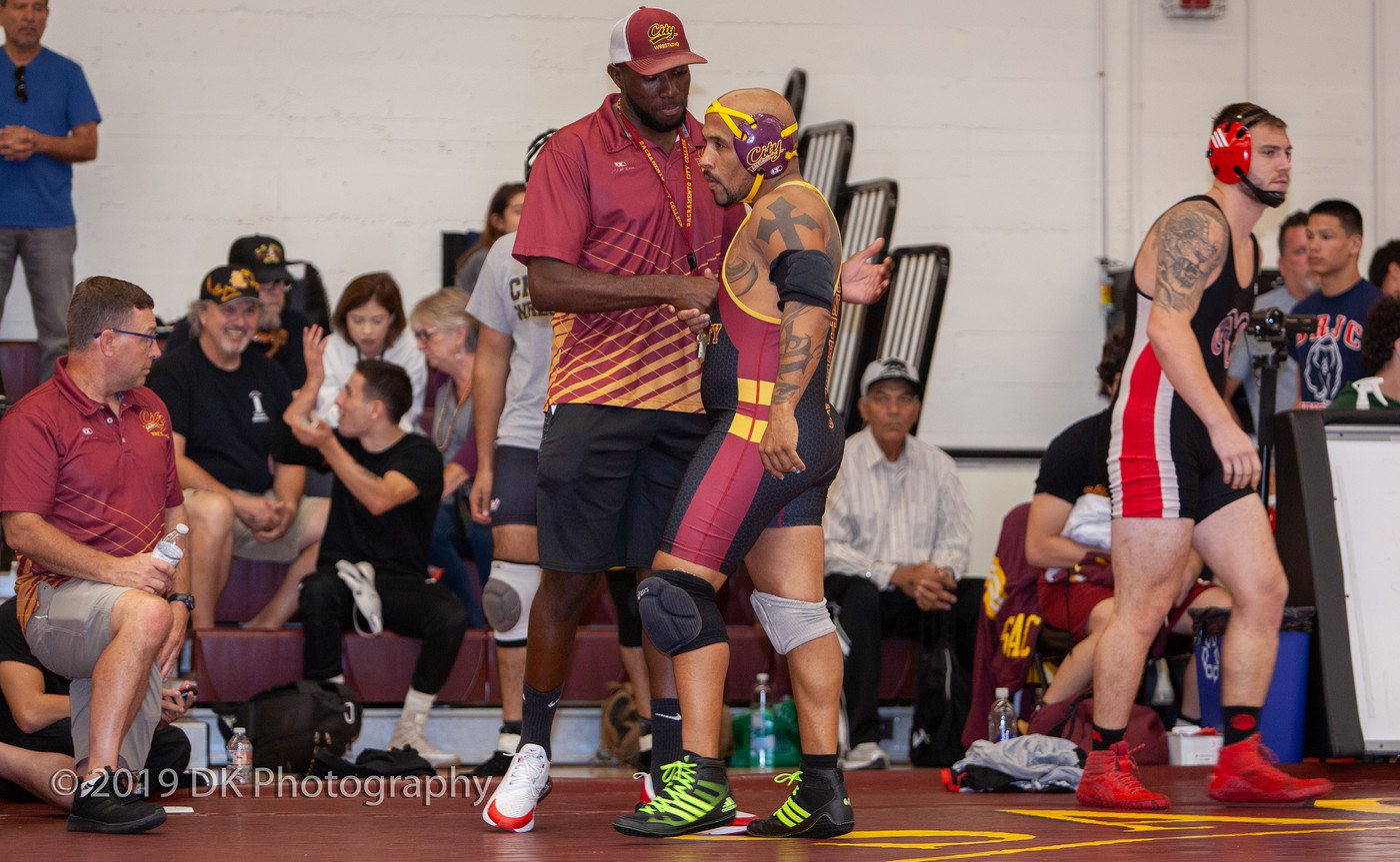 Marques  Gales, City College head coach talks to Edward Jensen-Machey before his first match at the Sac City Invite in the North Gym on Sept. 21st.