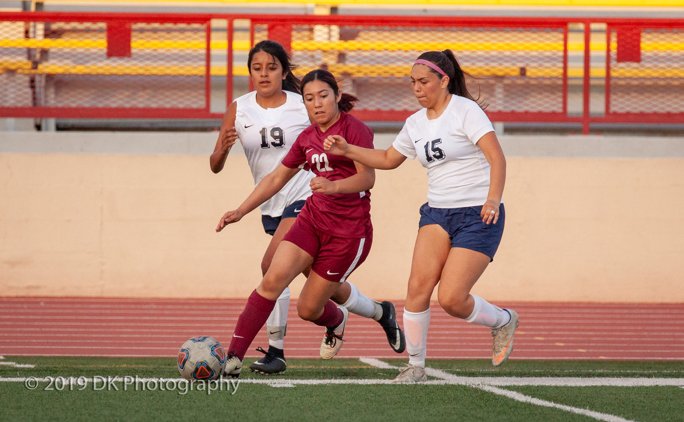Karina Quintero (#22) City College freshman splits the double team to move the ball up field in the match against Yuba College at Hughes Stadium on Aug. 27th.