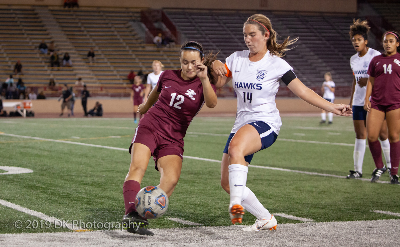 Alexis Dunbar (#12), City College freshman kicks the ball to a teammate in the match against Cosumnes River College at Hughes Stadium on Oct. 3rd.