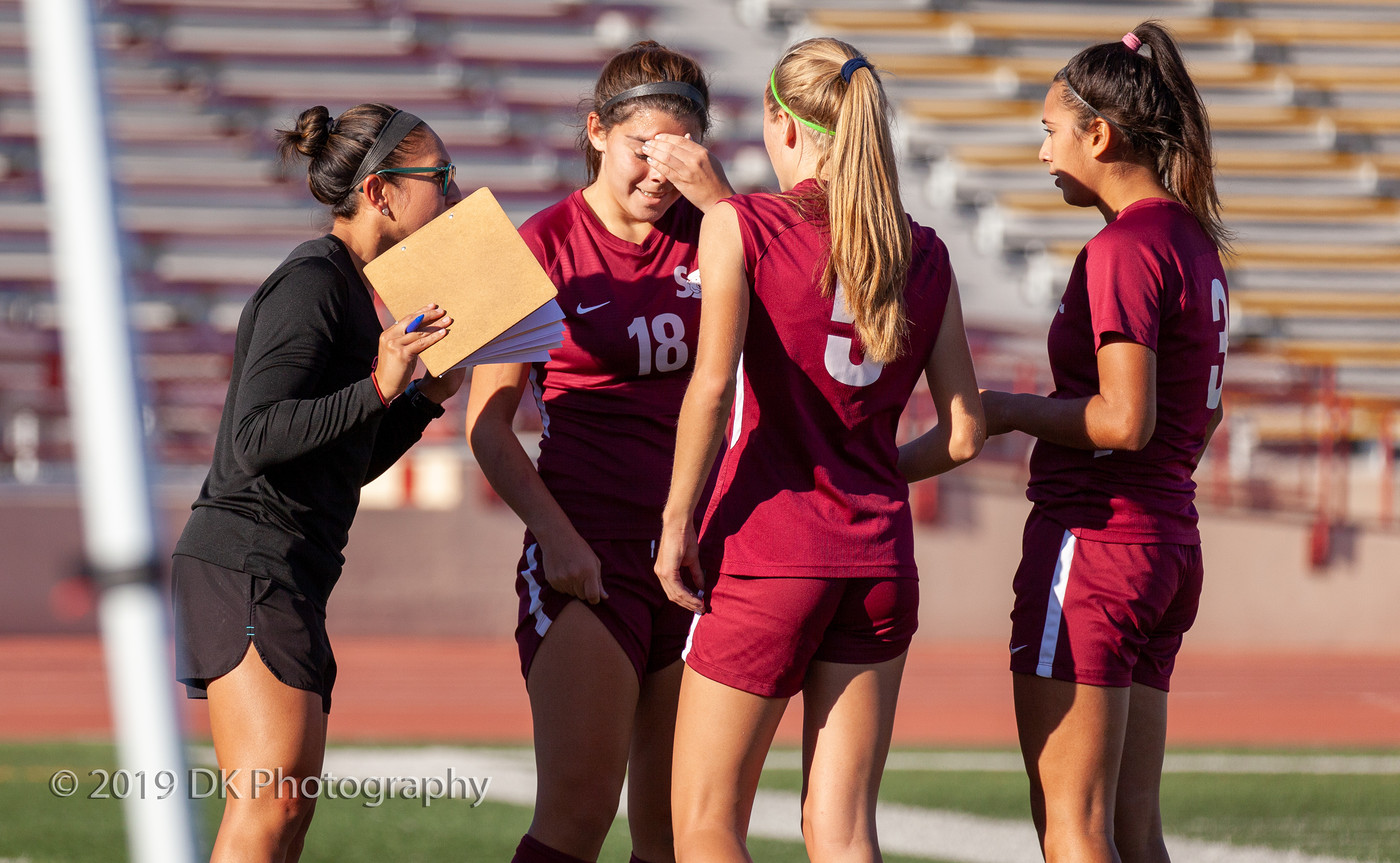 City College head coach Alexia Poon (left) talks to  Victoria Labardo (#18), Olivia Foulk  (#5) and Brianna Baggerly  (#3), during an injury on the field in the match against Santa Rosa College at Hughes Stadium on Nov. 1st.