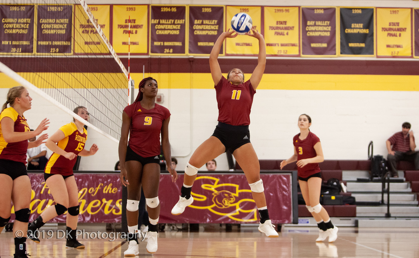 Ashley Ford(#11), City College freshman sets the ball in the match against Redwoods College in the North Gym on Sept. 4th.