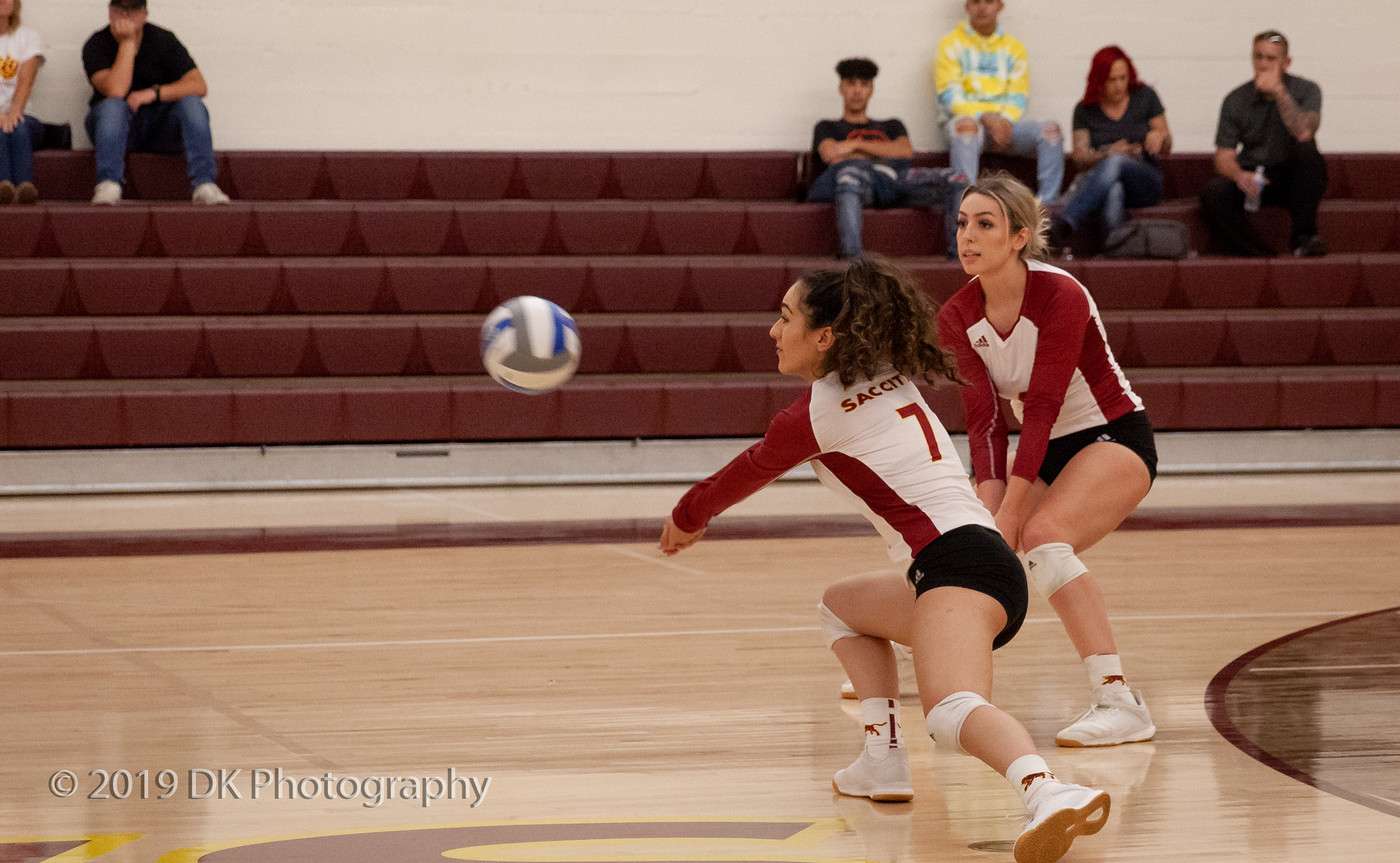 Nadia Sabbaghian (#7), City College freshman leans to dig the serve in the match against Modesto Junior College at the North Gym on Oct. 11th.